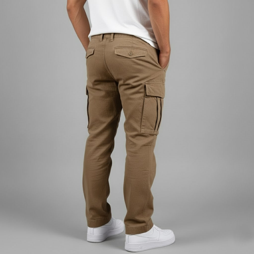 Man wearing brown relaxed-fit cotton cargo trousers with side pockets and back buttoned pockets.