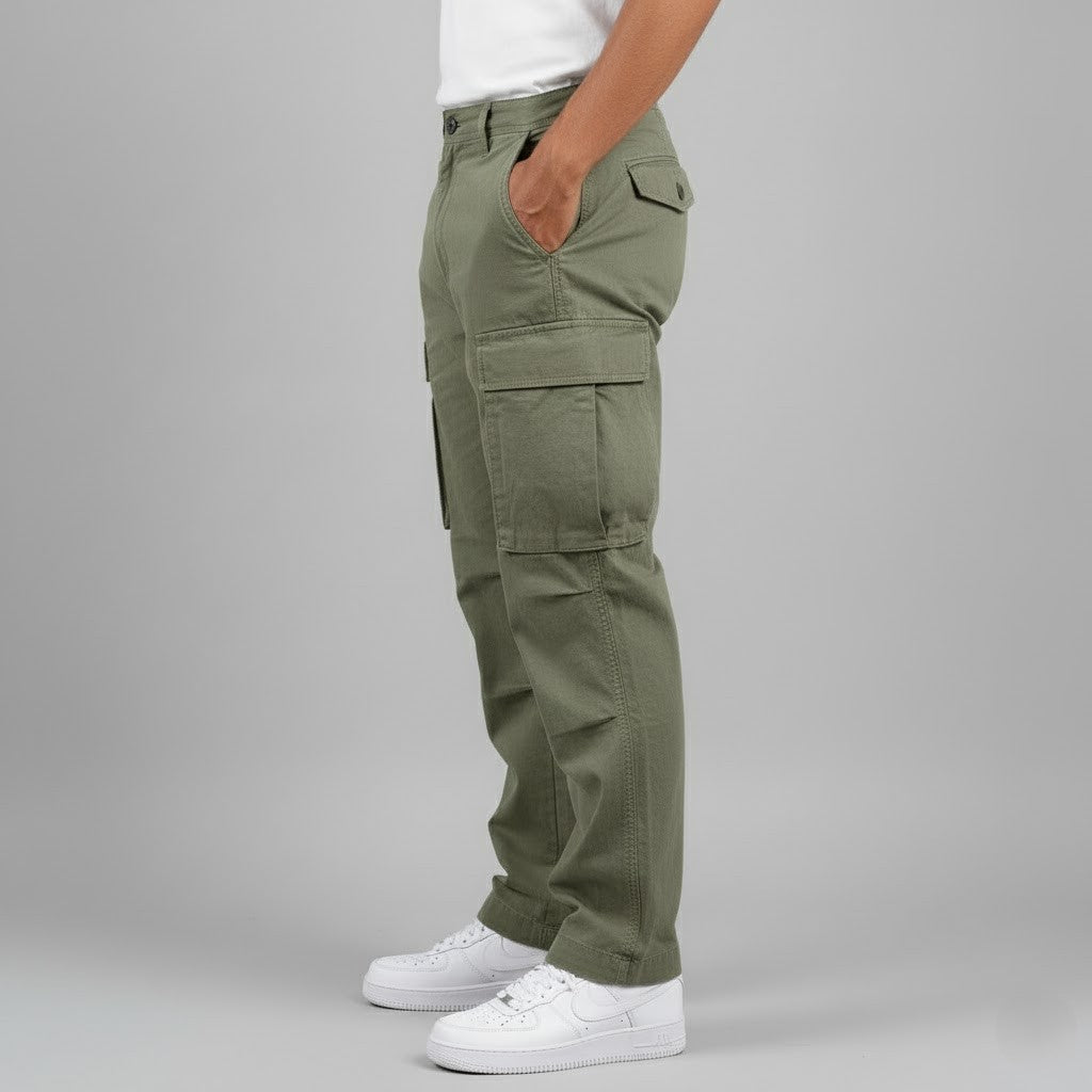 Men wearing olive green relaxed-fit cotton cargo trousers with side pockets and white sneakers.