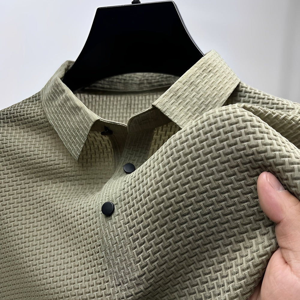 Sage green men's polo shirt featuring a waffle-weave textured fabric, spread collar, and a two-button placket.