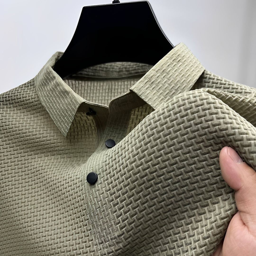 Sage green men's polo shirt featuring a waffle-weave textured fabric, spread collar, and a two-button placket.