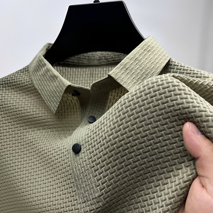 Sage green men's polo shirt featuring a waffle-weave textured fabric, spread collar, and a two-button placket.
