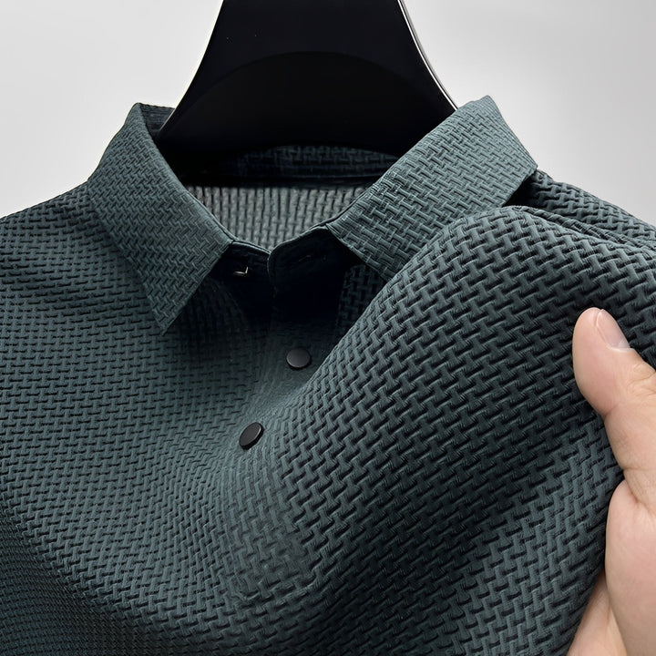 Dark green short sleeve polo shirt with a waffle-weave texture, spread collar, and two-button placket.