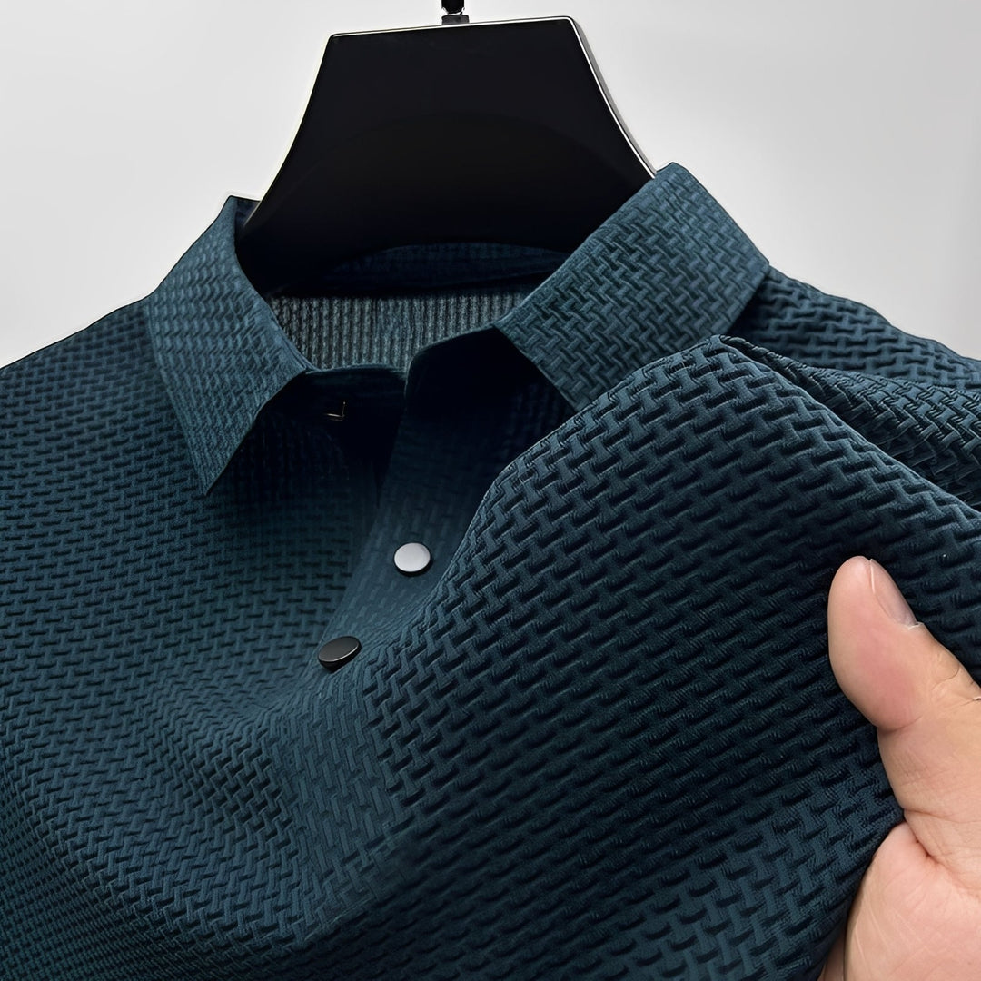 Dark teal short-sleeve polo shirt with a textured waffle-weave pattern, spread collar, and two-button placket.