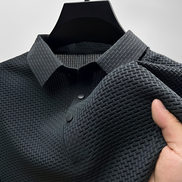 Black short-sleeve polo shirt featuring a textured waffle-weave fabric, a neat spread collar, and a two-button placket.