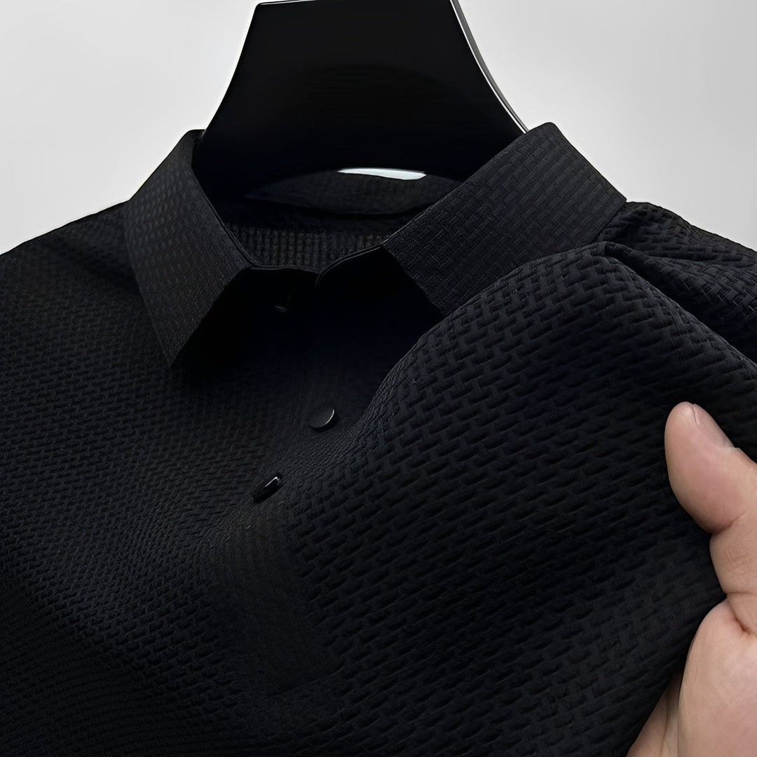 Black short-sleeve polo shirt with a textured waffle-weave finish, spread collar, and two-button placket.