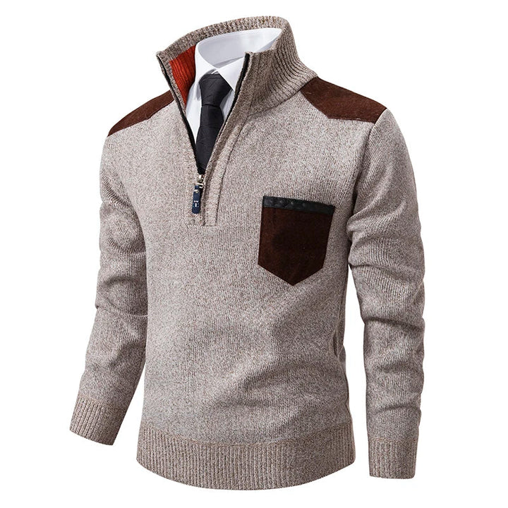 Beige marled knit quarter-zip jumper with brown shoulder and chest pocket patches, featuring a ribbed funnel neck and cuffs.