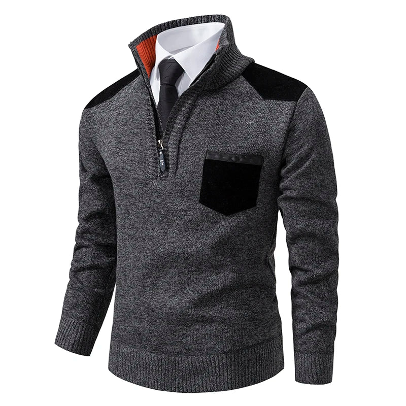 Grey marled knit quarter-zip jumper with black shoulder and chest pocket patches and an orange inner collar.