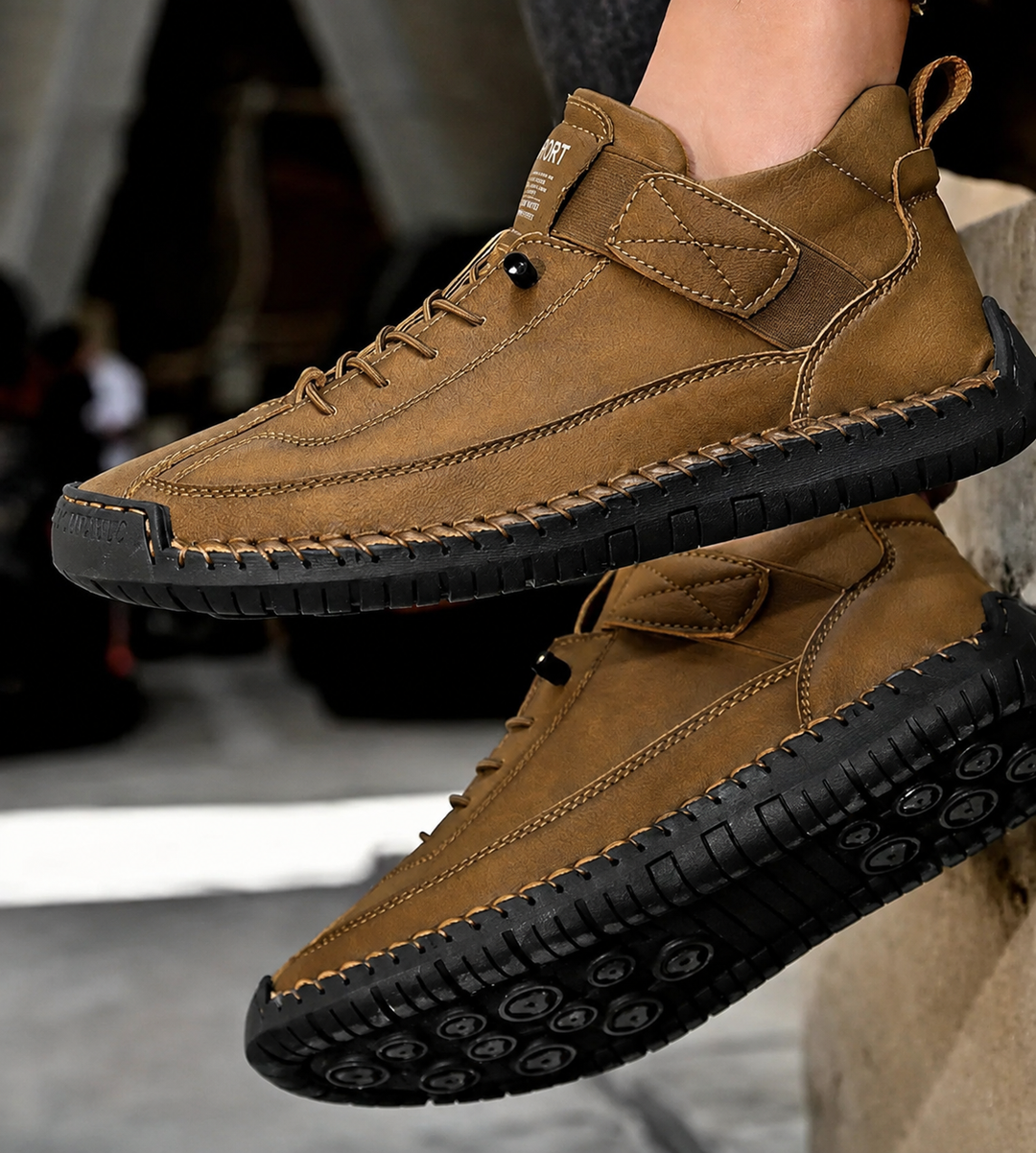 Tan Nora trainers featuring contrast stitching, a secure hook-and-loop strap, and a durable black treaded sole.