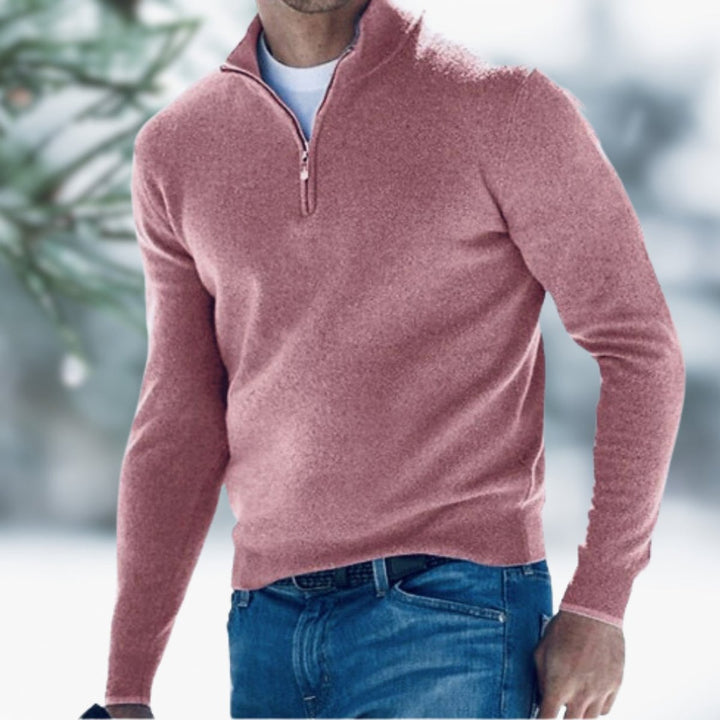 Men's slim-fit dusty rose quarter-zip knit sweater with a stand collar, worn over a white tee and blue jeans.