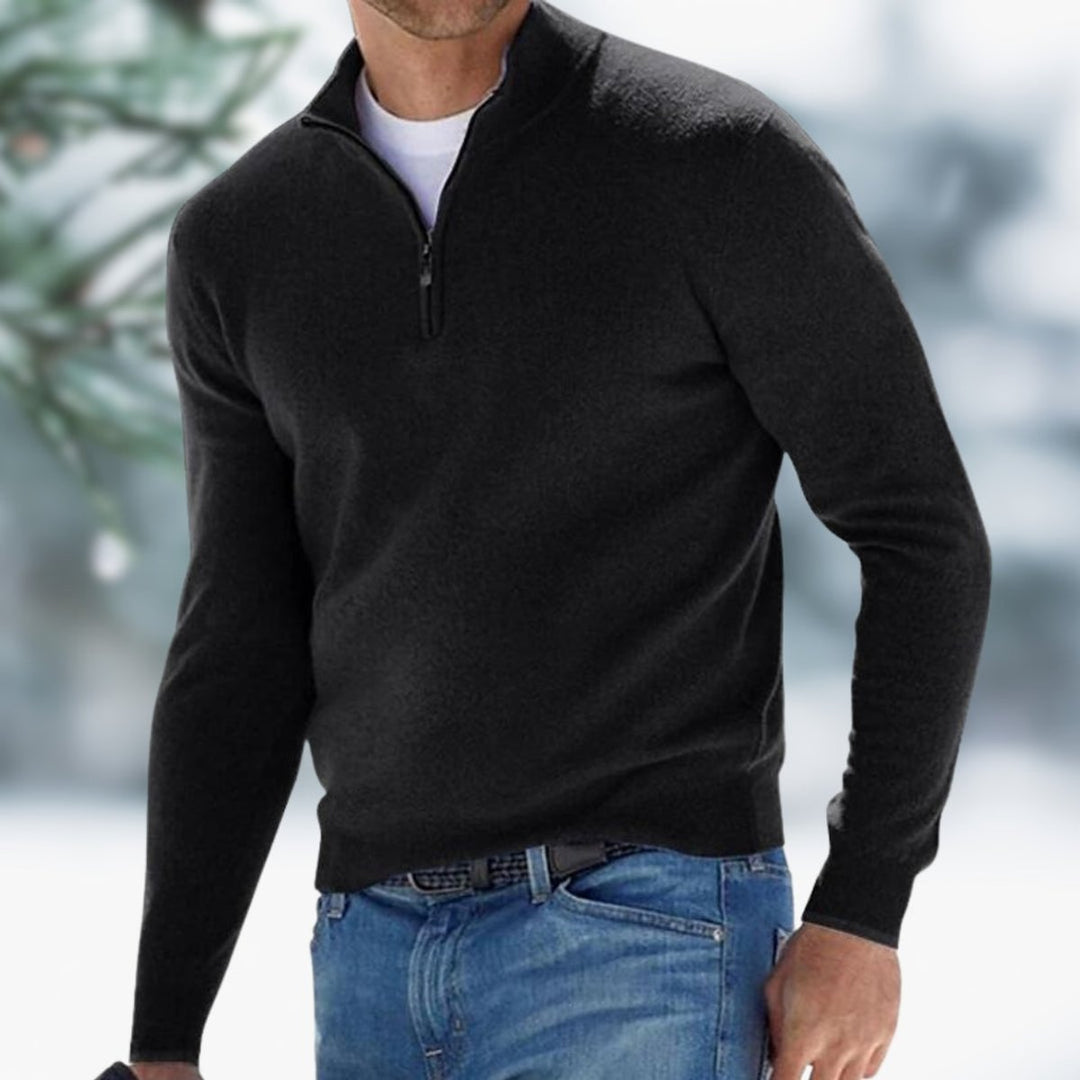 Men's slim-fit black quarter-zip knit sweater with a stand collar and ribbed cuffs worn over a white t-shirt.