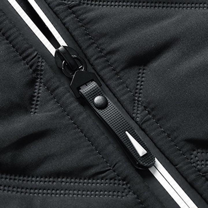 Close-up of a black quilted jacket featuring a chevron pattern, a sturdy zip fastening, and a textured pull tab.