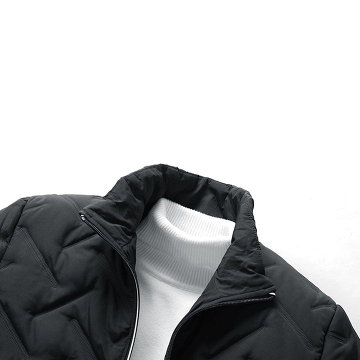 Black quilted chevron padded jacket with a stand-up collar layered over a white ribbed turtleneck sweater.