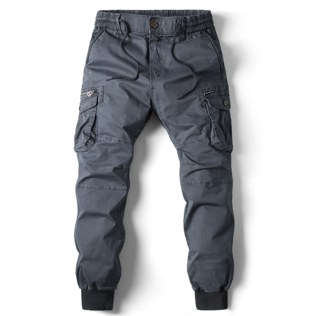 Charcoal grey men's utility cargo trousers with an elasticated drawstring waist, multiple side pockets, and cuffed ankles.