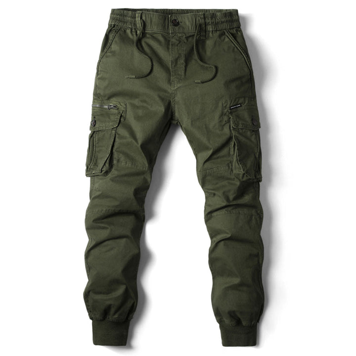 Olive green cotton cargo trousers with a drawstring waist, multiple utility pockets, and cuffed ankles on a white background.