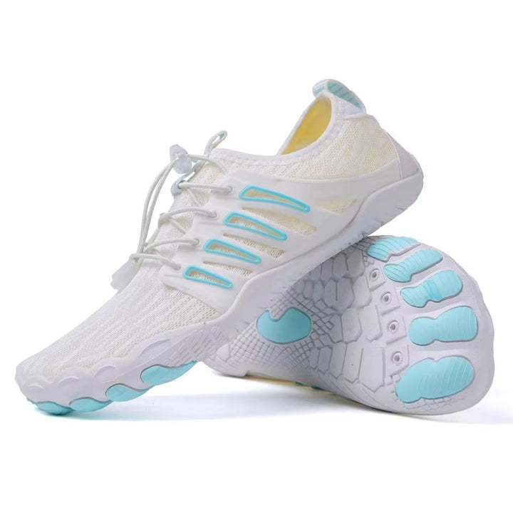 White lightweight barefoot walking shoe with breathable mesh, bungee laces, and light blue accents on a flexible rubber sole.