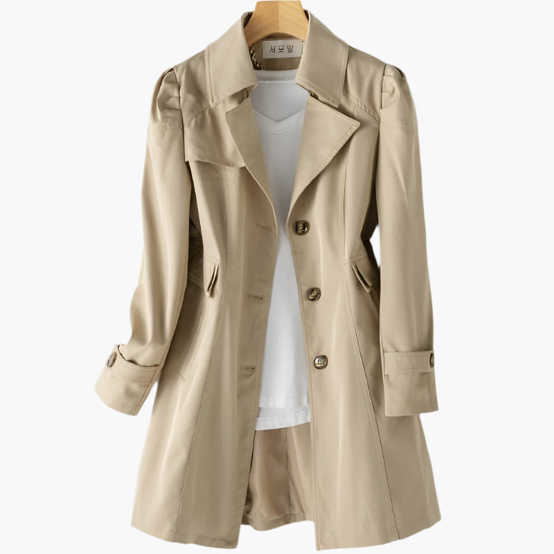 Beige tailored trench coat with a classic lapel, button front, and flattering cinched waist for a polished, timeless look.
