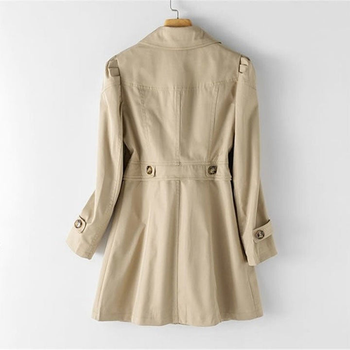 Back view of the Penelope beige tailored trench coat featuring a cinched waist, buttoned cuffs, and a classic mid-length silhouette.