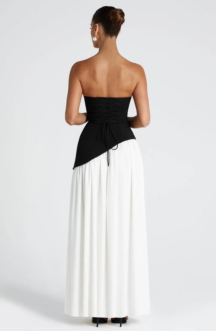 Phoebe black and white corset bustier maxi dress with a high slit and draped scarf detail.