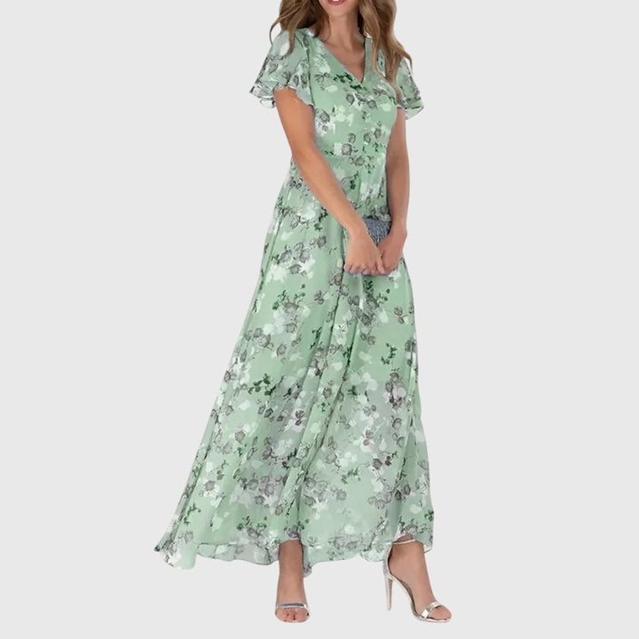Phoebe women's figure-flattering midi dress in light green with a delicate floral print, short sleeves, and tailored lines.