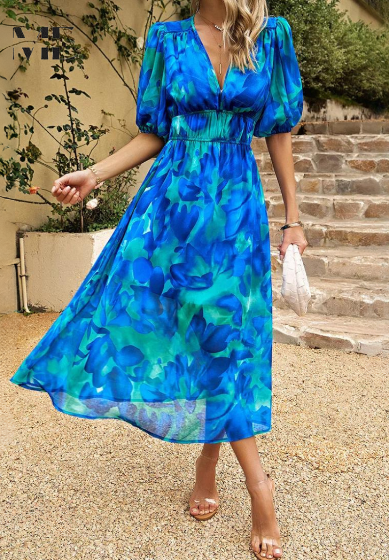 Blue and green floral midi dress with a V-neckline, gathered waist, and romantic puff sleeves.