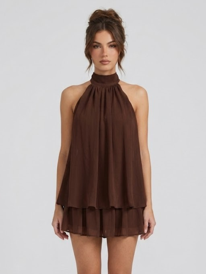 Dark brown halter neck mini dress with a tiered ruffle hem and lightweight, flowy fabric.