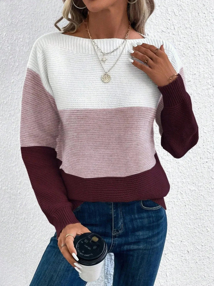Women's chunky knit jumper featuring a white, pink, and burgundy colour block design with a relaxed boat neckline.