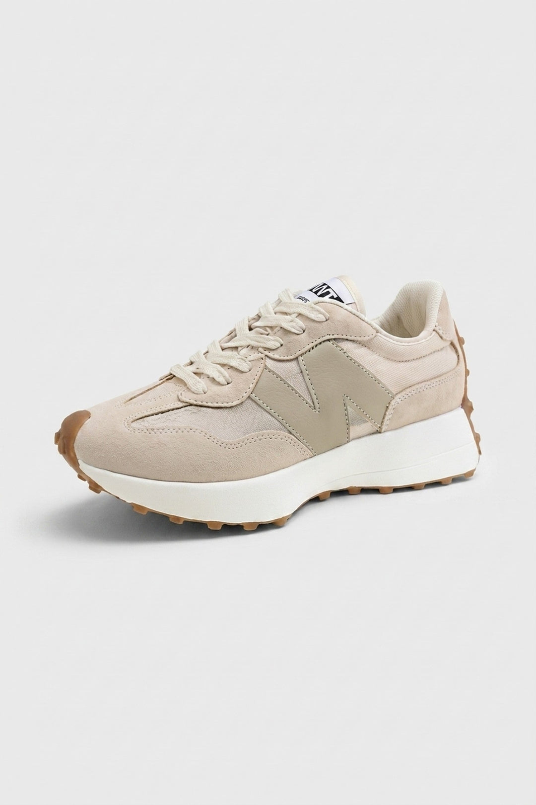 Beige retro lace-up trainers with mixed-panel suede and canvas upper, white cushioned midsole, and gum rubber outsole.