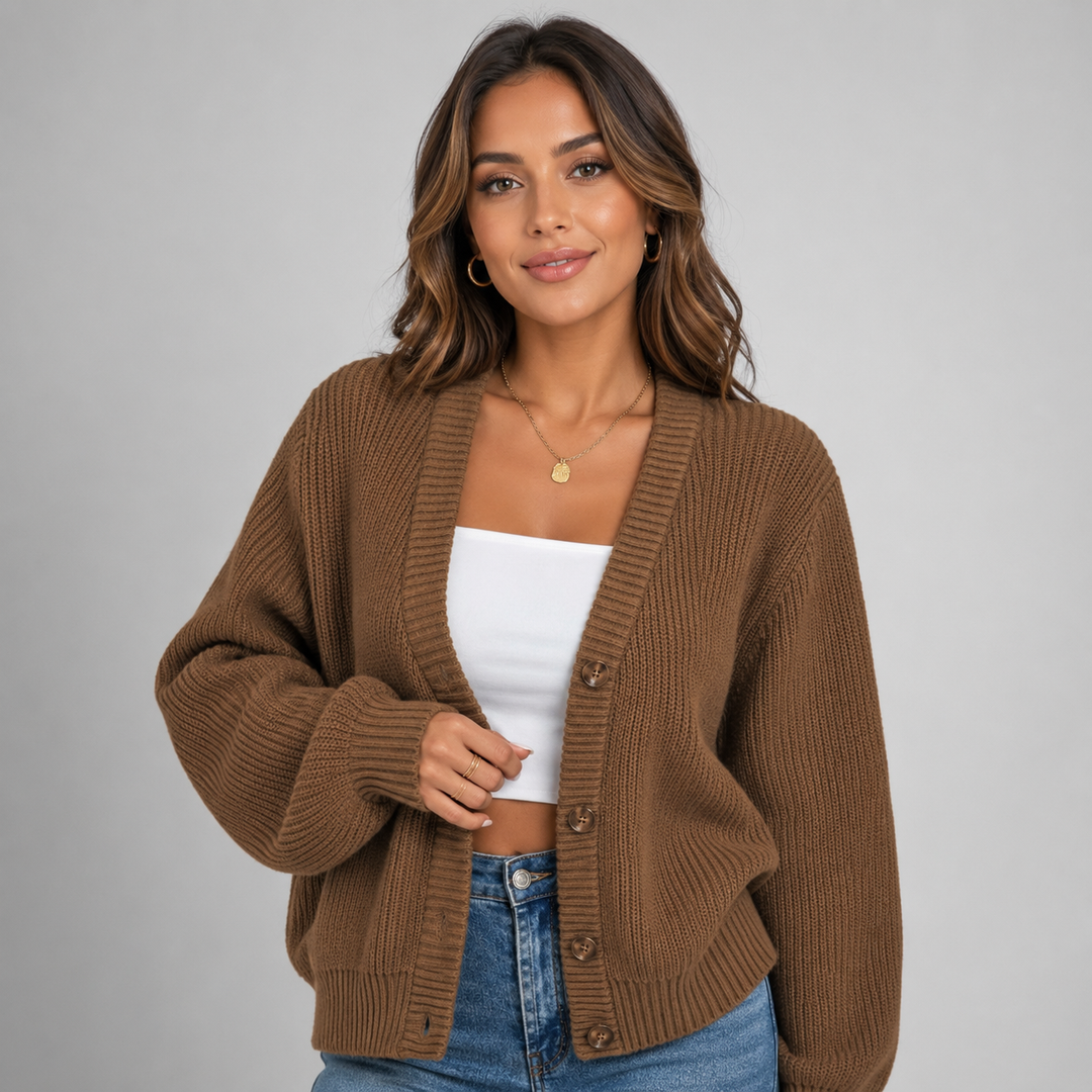 Woman wearing a cozy brown ribbed knit cardigan with a V-neck, button-front closure, and relaxed oversized fit.