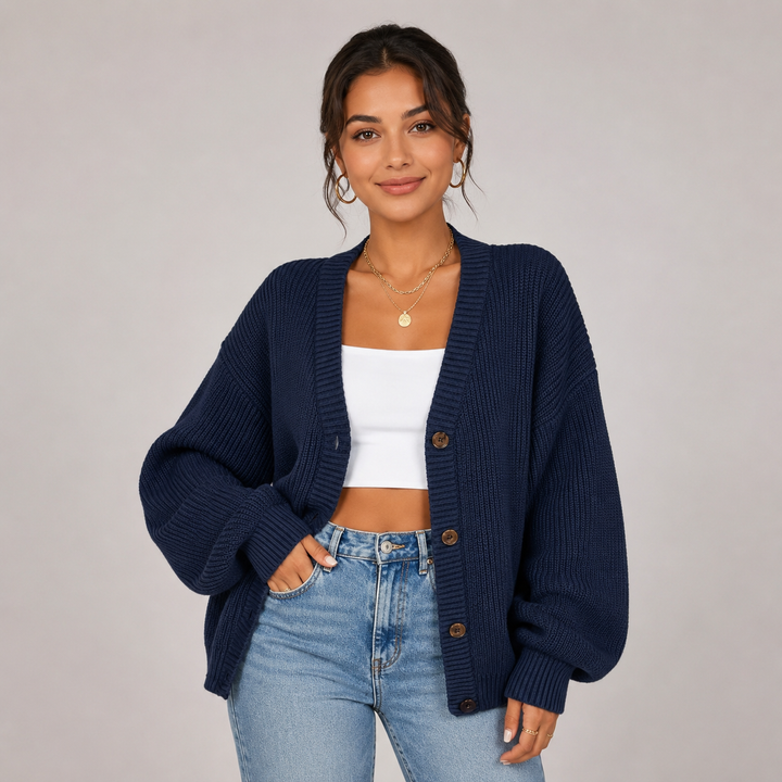 Navy blue ribbed knit cardigan with a relaxed oversized fit, V-neckline, and front button closure.