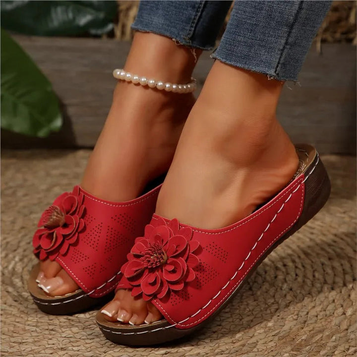Red Poppy women's slip-on wedge sandals with delicate floral upper detail and cushioned footbed.