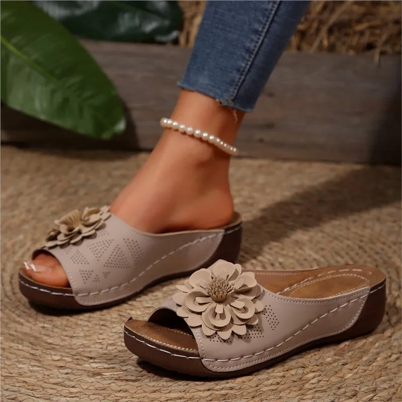 Poppy women's beige slip-on wedge sandals with delicate floral upper detail and cushioned footbed.