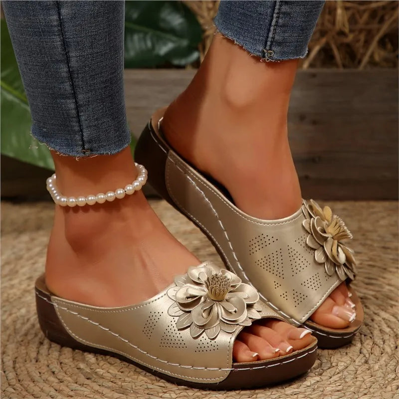 Poppy women's gold slip-on wedge sandals with delicate floral upper detail and cushioned footbed.