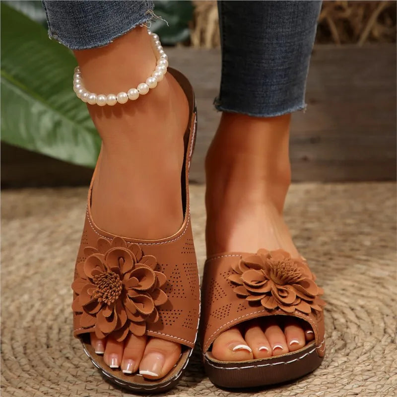 Brown Poppy women's slip-on wedge sandals with delicate floral upper detail and cushioned footbed.