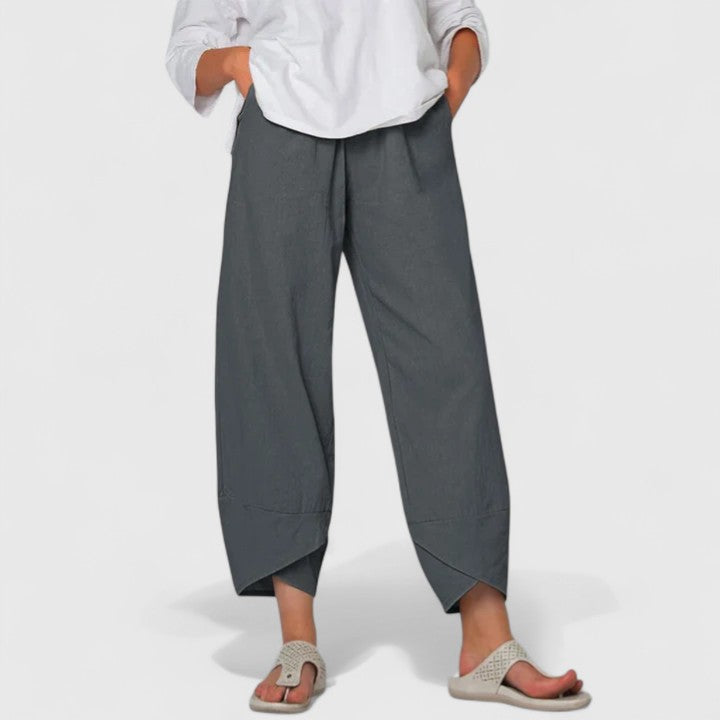 Poppy women's wide-leg trousers in charcoal gray, featuring a relaxed fit, handy pockets, and flowing drape.