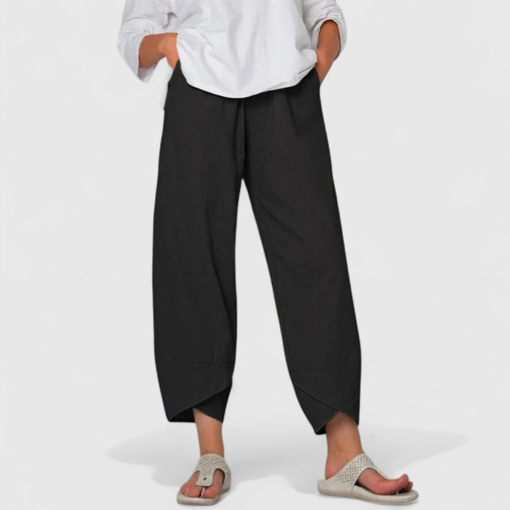 Poppy women's black wide-leg trousers with a relaxed fit, flowing silhouette, and handy pockets.