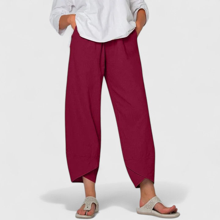 Poppy women's wide-leg trousers in rich cranberry, featuring a relaxed fit, flowing drape, and handy pockets.