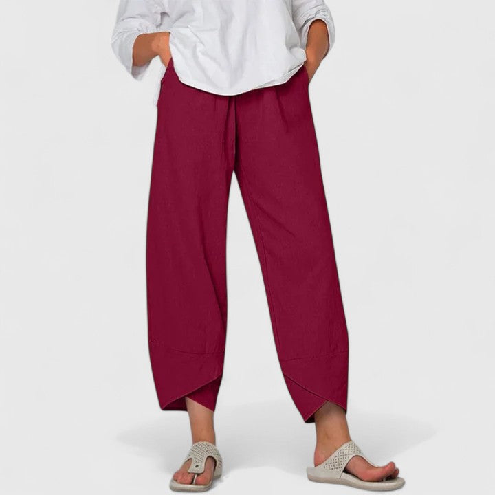 Poppy women's wide-leg trousers in a rich red, featuring a relaxed fit, flowing drape, and handy pockets.