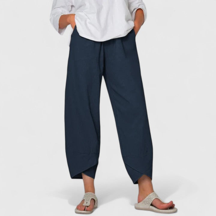 Poppy women's wide-leg trousers in navy, featuring a relaxed fit, flowing drape, and handy pockets.