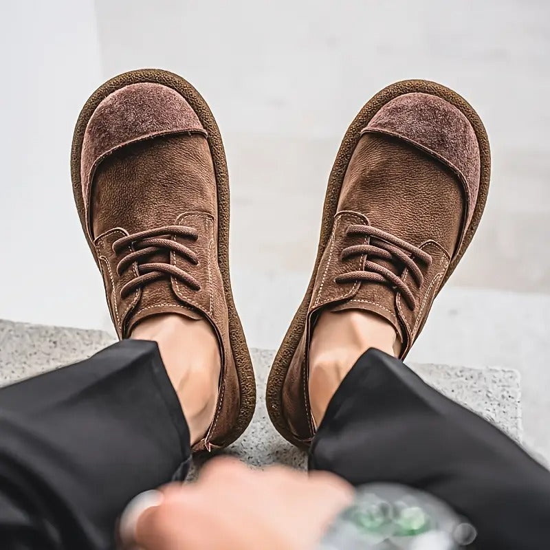 Men's brown suede lace-up walking shoes with a rounded toe, textured finish, and thick cushioned soles.