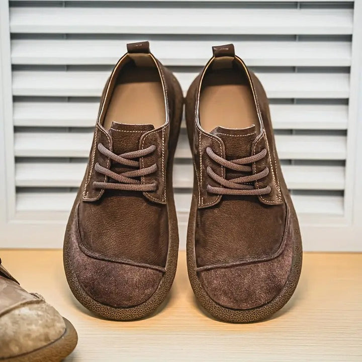 Men's brown leather lace-up walking shoes featuring a rounded toe, cushioned sole, and textured suede accents.
