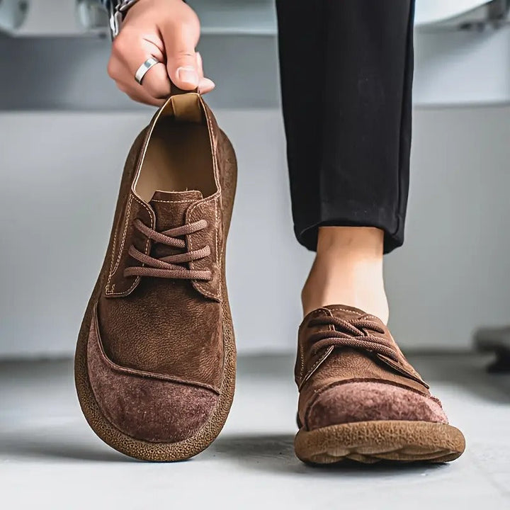 Brown suede lace-up walking shoes with a rounded toe and cushioned textured sole for men.