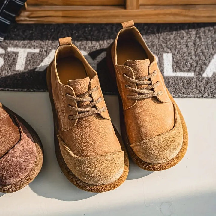Tan leather lace-up walking shoes with a rounded toe, suede cap, and textured cushioned sole for men.