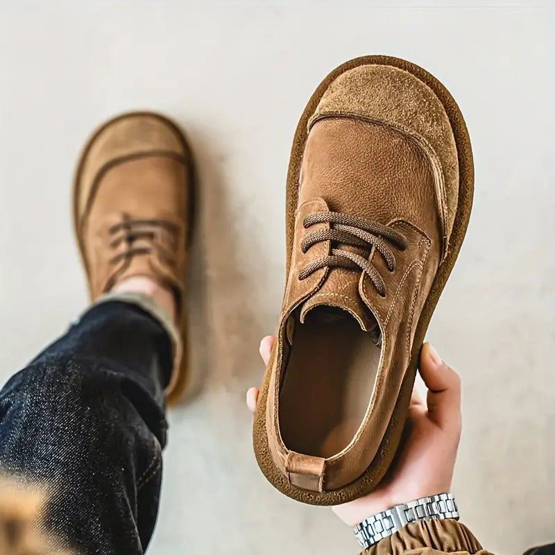 Men's brown suede lace-up walking shoes featuring a rounded toe, cushioned sole, and a low-profile casual design.
