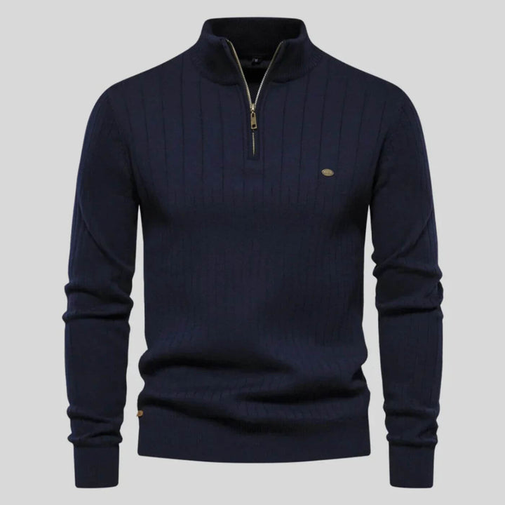 Navy blue men's ribbed half-zip knit jumper with a high collar, long sleeves, and a subtle metallic chest logo.