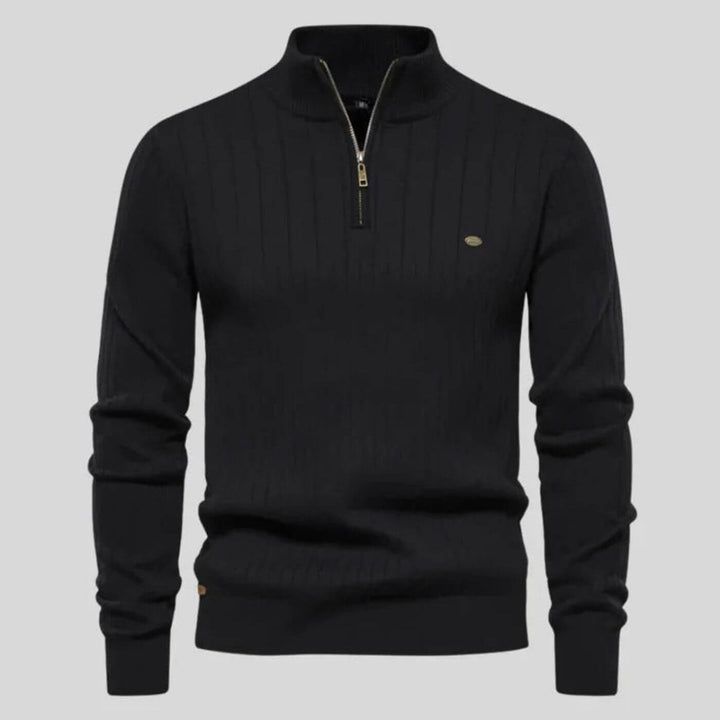 Black ribbed knit jumper with a half-zip collar, long sleeves, and a subtle metallic chest logo detail.
