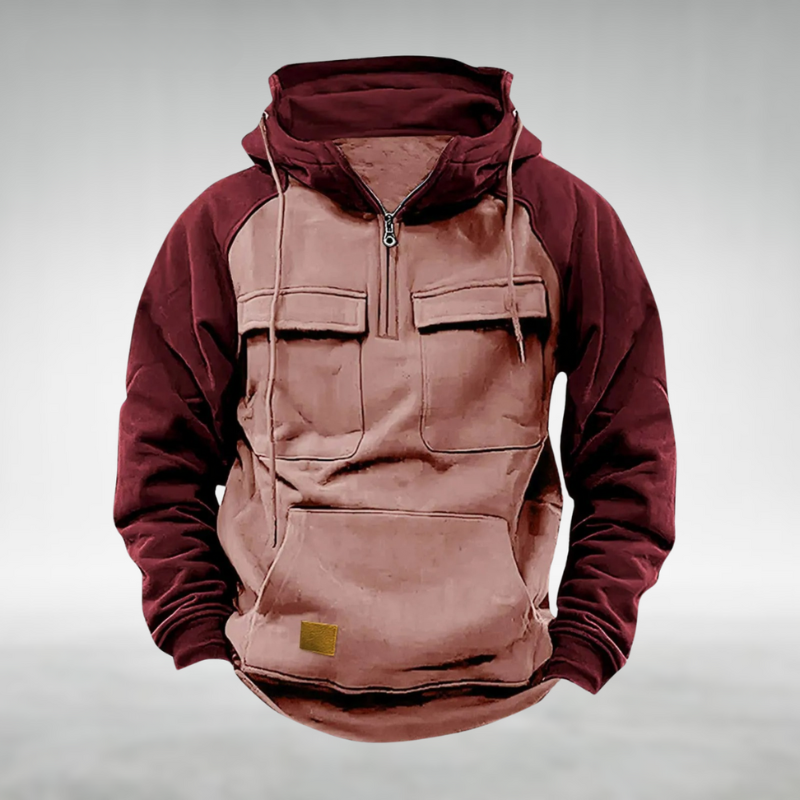 Men's two-tone burgundy and tan half-zip utility hoodie with chest flap pockets, kangaroo pocket, and drawstring hood.