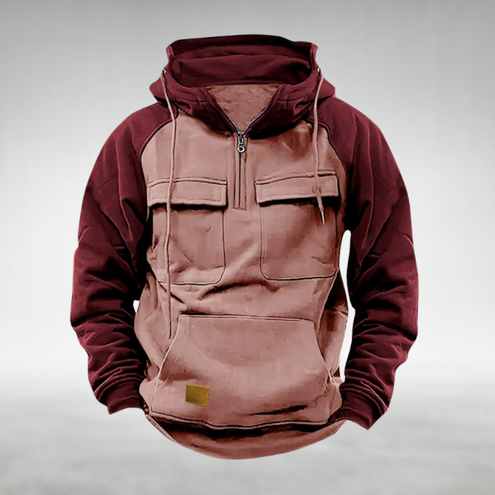 Men's two-tone burgundy and tan half-zip utility hoodie with chest flap pockets, kangaroo pocket, and drawstring hood.