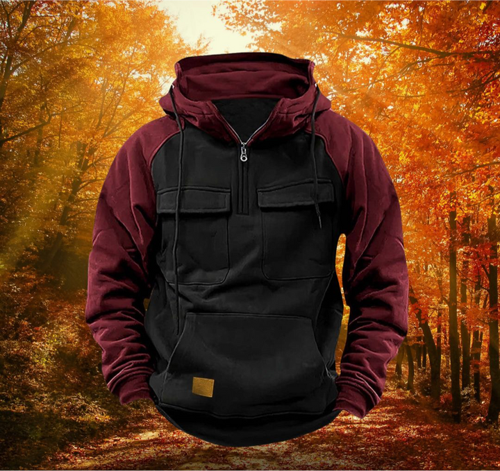 Men's burgundy and black colour-block half-zip utility hoodie with chest flap pockets and a drawstring hood.