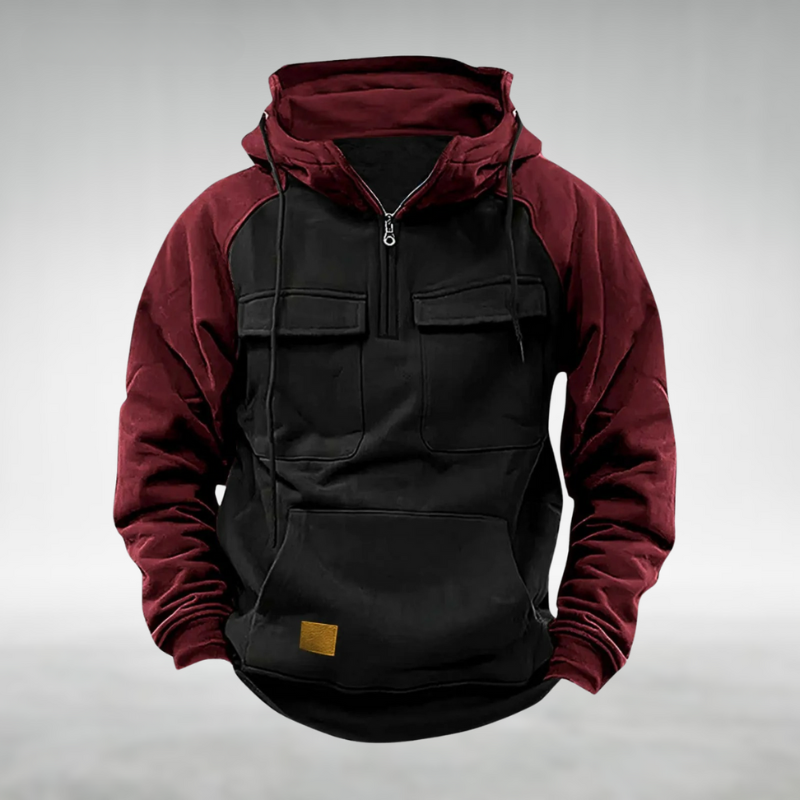 Men's burgundy and black colour-block half-zip hoodie with chest flap pockets, kangaroo pocket, and drawstring hood.