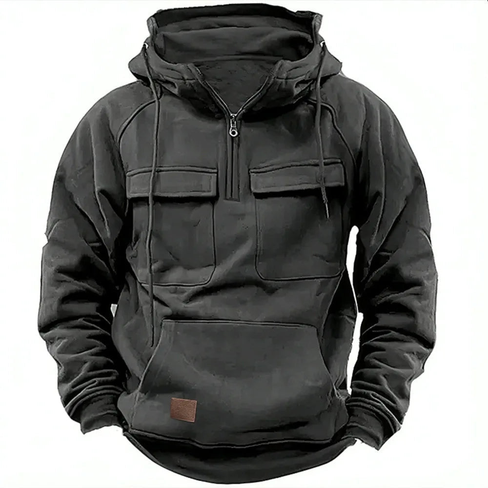 Black men's utility hoodie featuring a half-zip neckline, drawstring hood, dual chest flap pockets, and a kangaroo pocket.